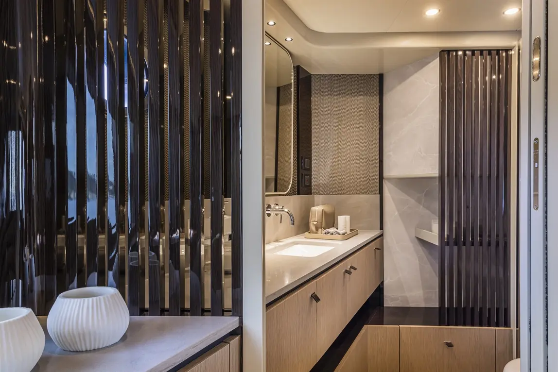 Modern bathroom design featuring a sink, elegant storage, decorative vases, and stylish wall panels.